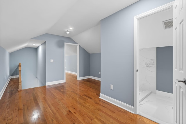 bonus room featuring hardwood / wood-style floors and lofted ceiling