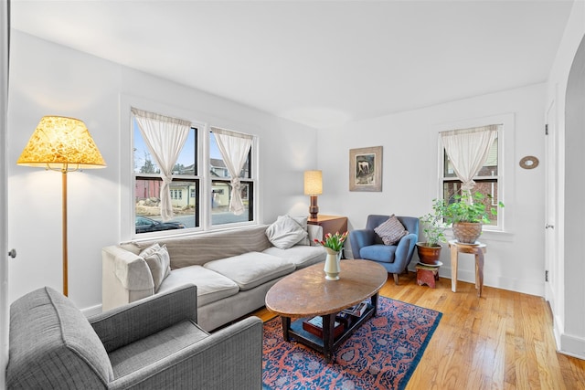 living room with plenty of natural light and hardwood / wood-style floors