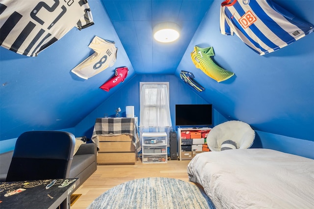 bedroom with hardwood / wood-style flooring and lofted ceiling