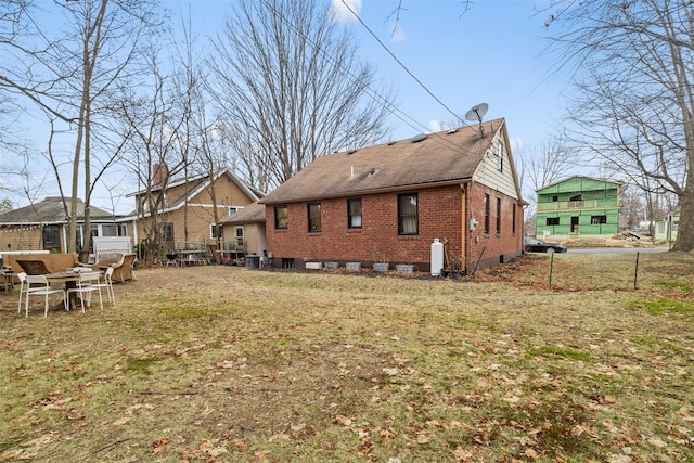 rear view of property featuring a yard