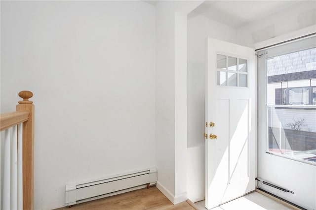 foyer featuring light hardwood / wood-style floors and baseboard heating