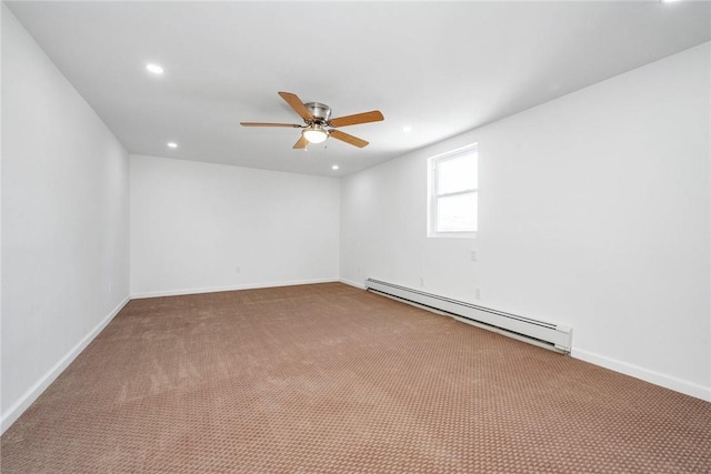 spare room with carpet, ceiling fan, and a baseboard heating unit