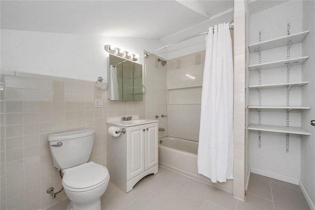 full bathroom with shower / bath combination with curtain, vanity, tile walls, tile patterned flooring, and toilet