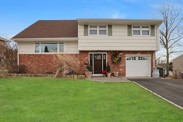 split level home with a front yard and a garage