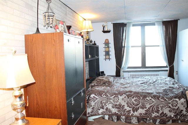 bedroom featuring brick wall