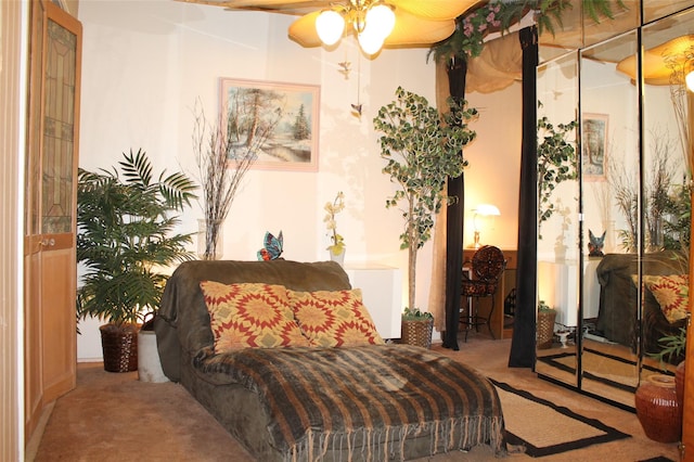 sitting room with carpet, ceiling fan, and radiator