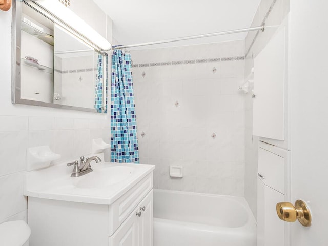 full bathroom with backsplash, vanity, shower / tub combo with curtain, tile walls, and toilet