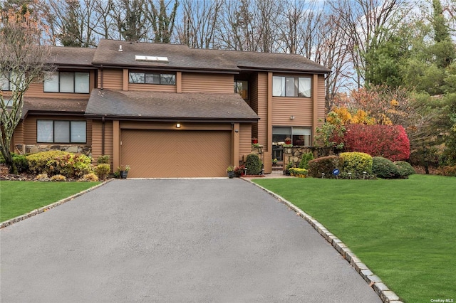 view of front of house with a front lawn and a garage