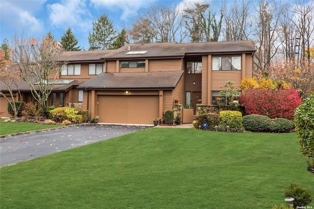 view of front facade with a garage and a front lawn