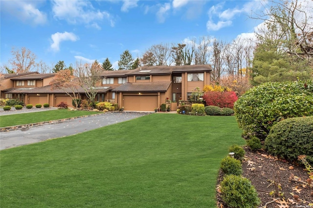 view of front of home featuring a garage and a front lawn