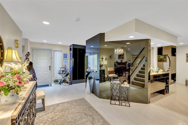 entrance foyer featuring light wood-type flooring and a notable chandelier