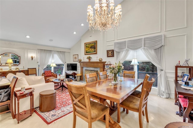 dining space featuring lofted ceiling, a premium fireplace, and a chandelier