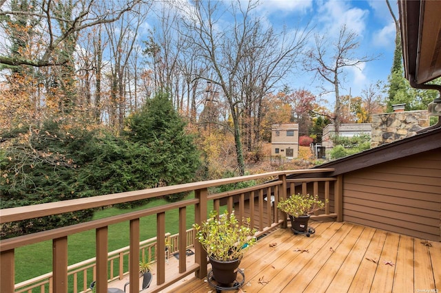 wooden deck featuring a yard