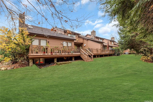 back of house with a lawn and a deck