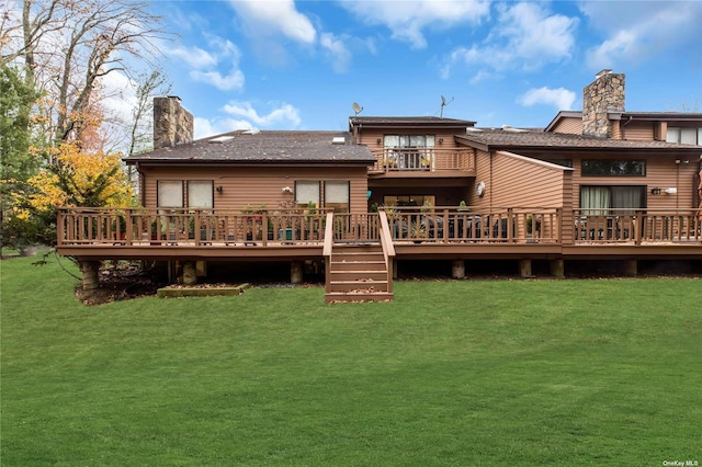 back of property with a wooden deck and a lawn