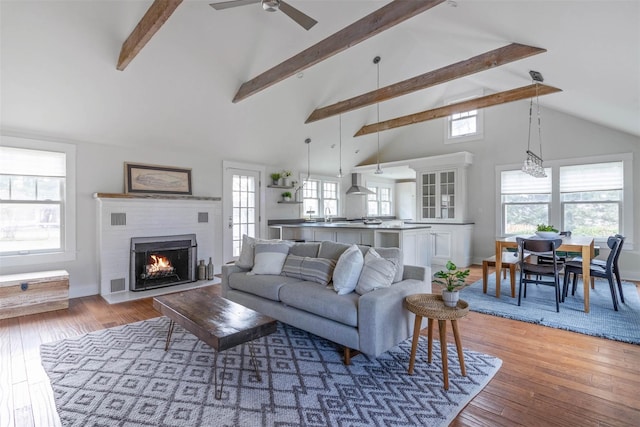 living room featuring a wealth of natural light, hardwood / wood-style floors, and high vaulted ceiling