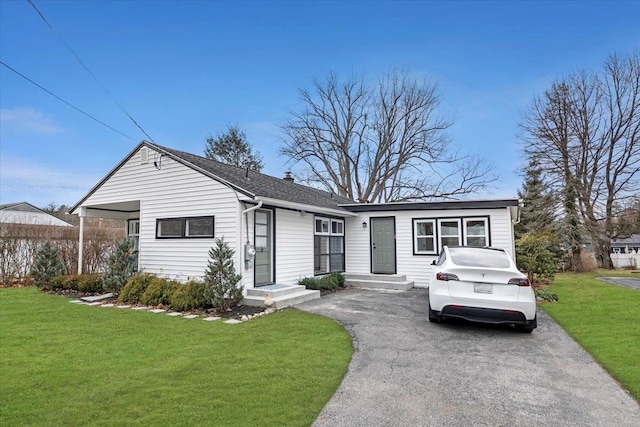 ranch-style house with a front yard and a carport