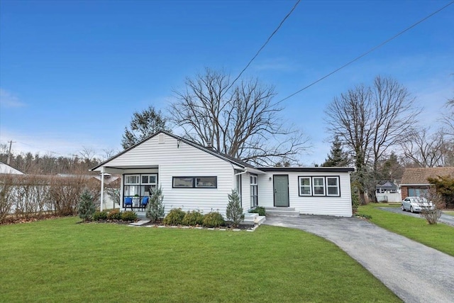 ranch-style home featuring a front yard