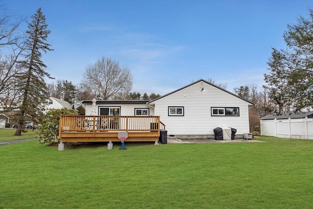 rear view of house featuring a yard and a wooden deck