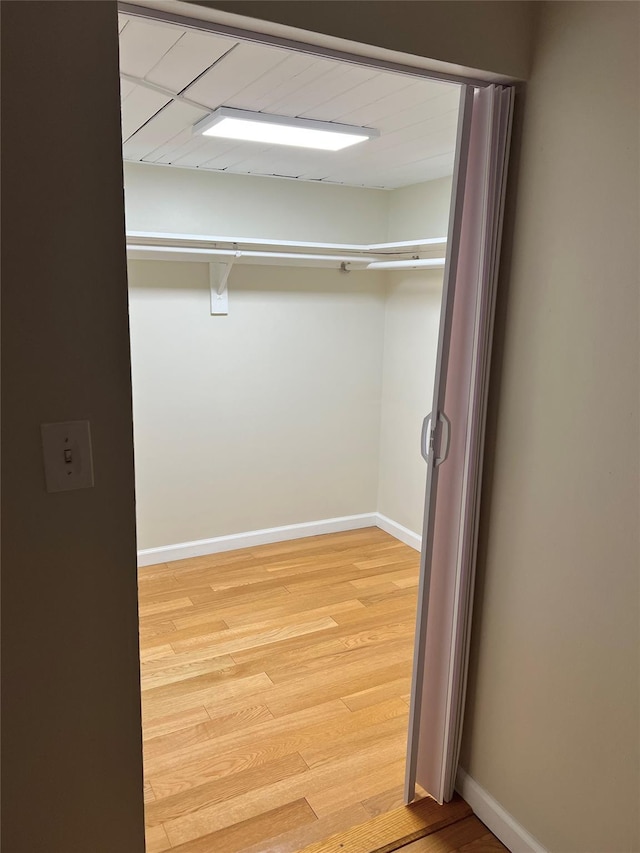 walk in closet featuring light hardwood / wood-style flooring