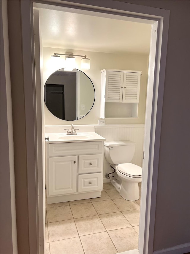 bathroom featuring tile patterned flooring, vanity, and toilet