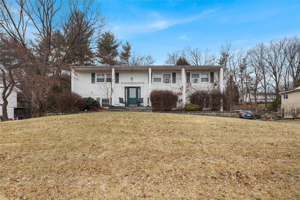 rear view of property with a lawn