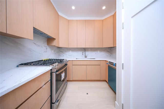 kitchen with light brown cabinets, backsplash, stainless steel appliances, and sink