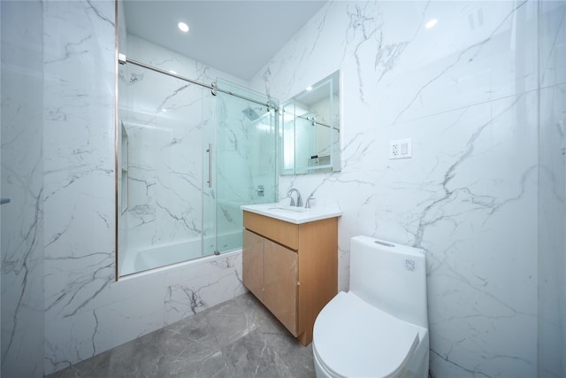 full bathroom with vanity, toilet, and bath / shower combo with glass door