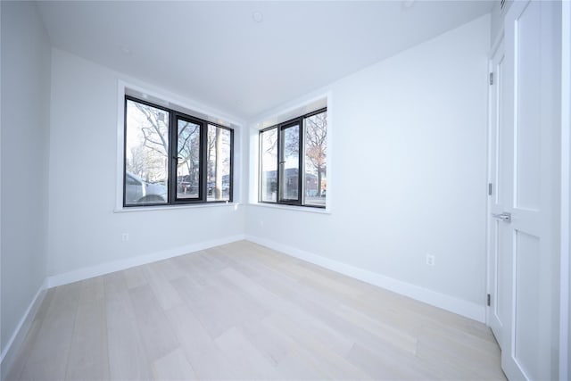 unfurnished room with light hardwood / wood-style flooring