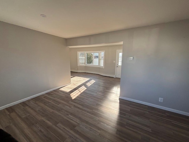 empty room with dark hardwood / wood-style floors