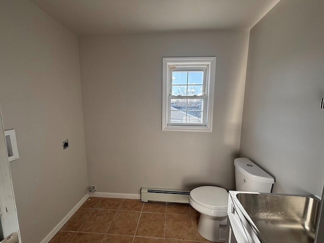 bathroom featuring vanity, a baseboard heating unit, tile patterned floors, and toilet