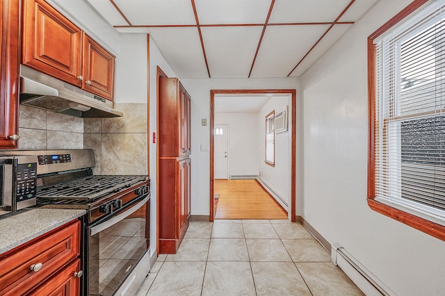 kitchen with tasteful backsplash, light tile patterned floors, stainless steel appliances, and a baseboard radiator