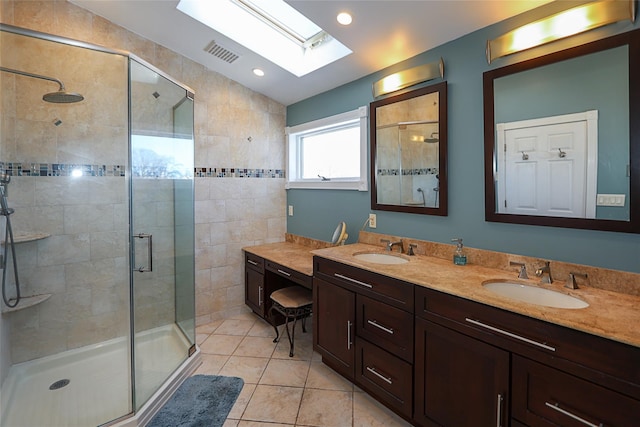 bathroom with vanity, tile patterned floors, an enclosed shower, and lofted ceiling with skylight