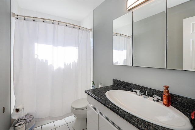 bathroom featuring tile patterned flooring, vanity, a shower with shower curtain, and toilet