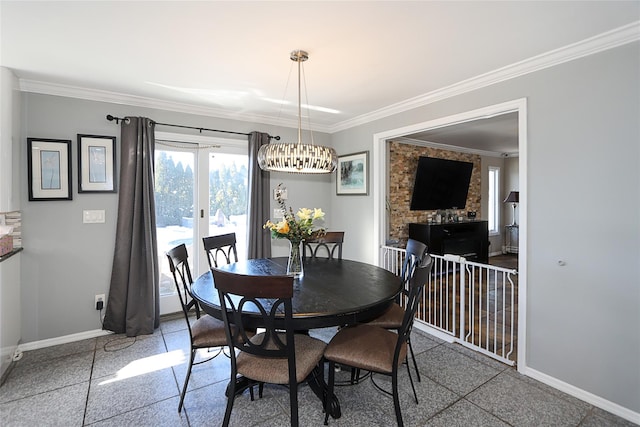 dining room featuring a notable chandelier, ornamental molding, and french doors