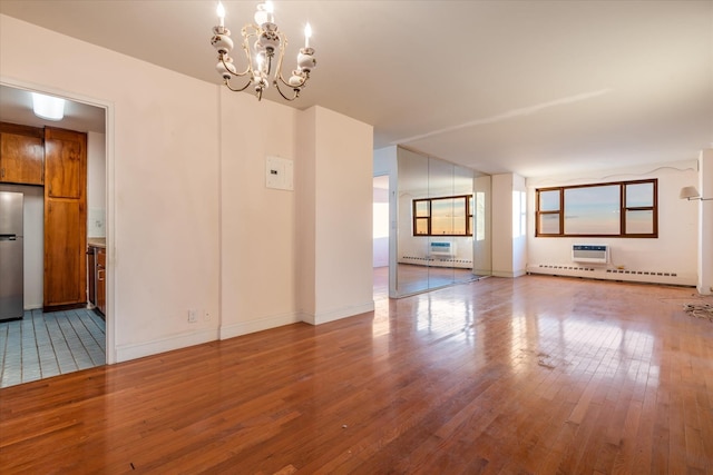 unfurnished living room featuring light hardwood / wood-style floors and an inviting chandelier