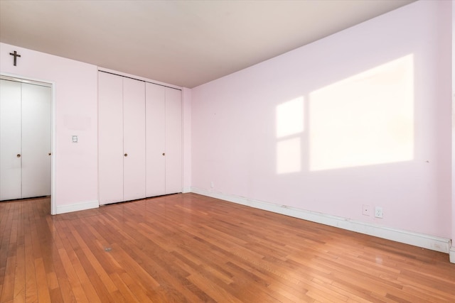 unfurnished bedroom with wood-type flooring