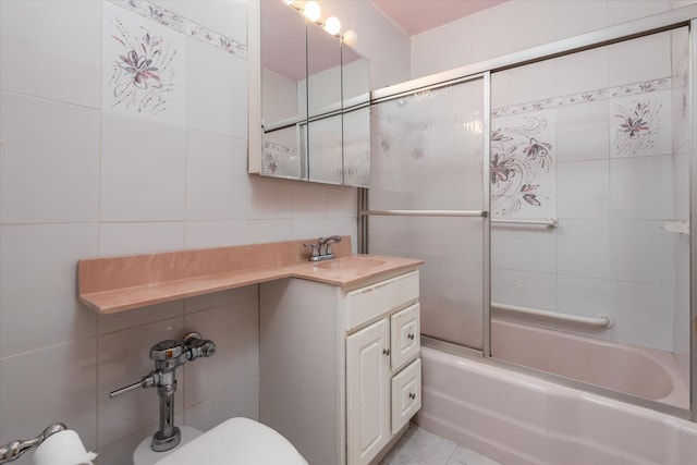 full bathroom with vanity, decorative backsplash, toilet, enclosed tub / shower combo, and tile walls