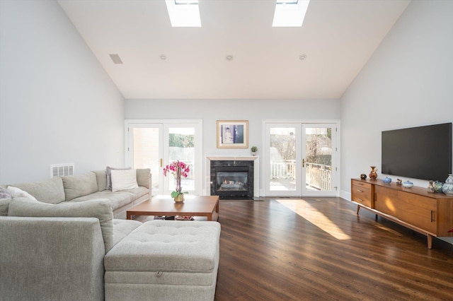 living room featuring dark hardwood / wood-style floors, french doors, and a healthy amount of sunlight