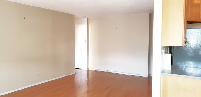 empty room featuring wood-type flooring