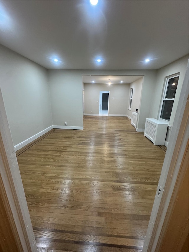 interior space with hardwood / wood-style flooring and radiator