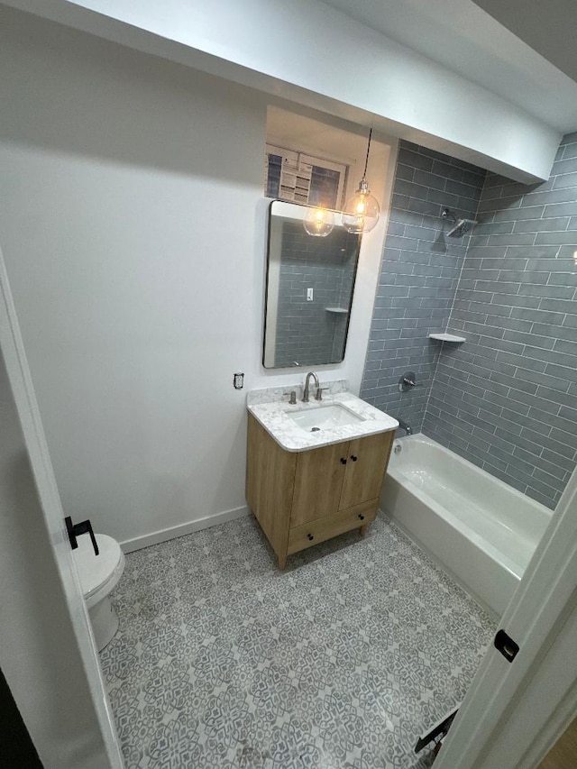 full bathroom featuring tiled shower / bath combo, toilet, and vanity