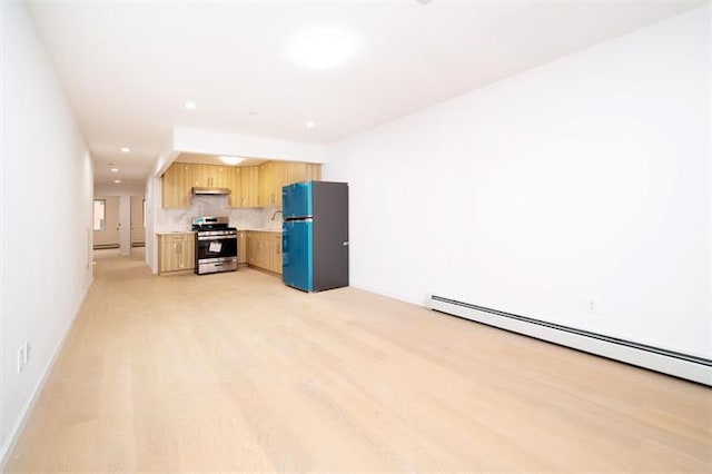 kitchen featuring light hardwood / wood-style floors, black fridge, stainless steel range, and a baseboard heating unit