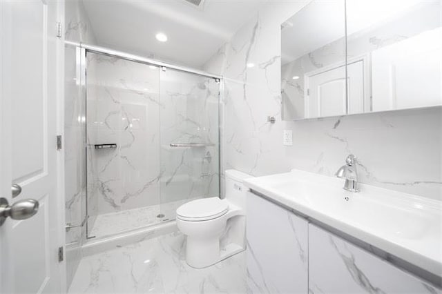 bathroom with backsplash, a shower with door, vanity, and toilet