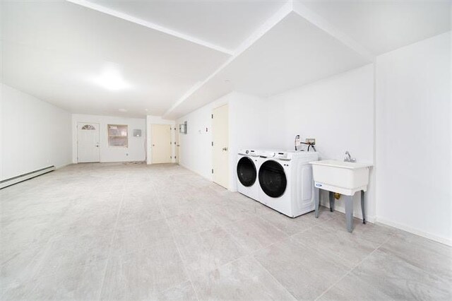 laundry area with independent washer and dryer and a baseboard radiator