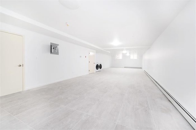 empty room featuring washer / clothes dryer and a baseboard radiator