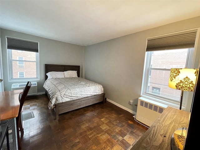 bedroom with radiator heating unit and a wall mounted AC