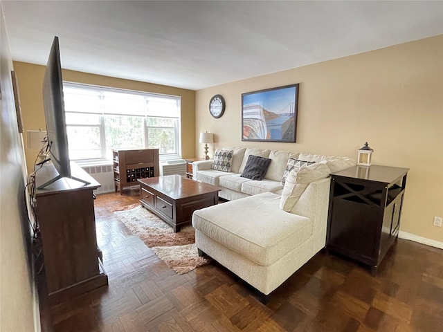 living room with radiator heating unit and dark parquet floors