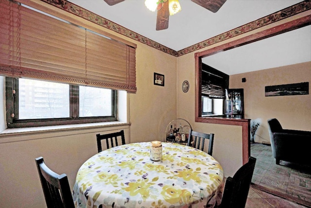 dining space featuring ceiling fan and tile patterned floors