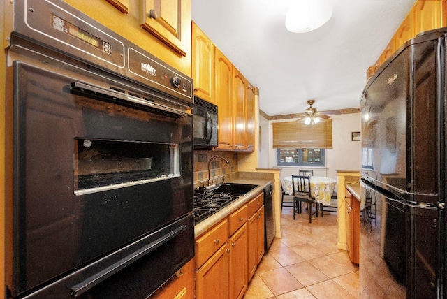 kitchen featuring black appliances, tasteful backsplash, light tile patterned flooring, ceiling fan, and sink